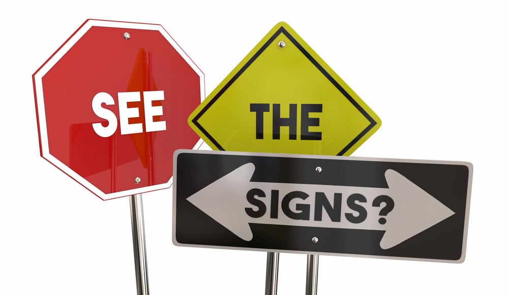 Three road signs display the words 